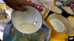FILE - A worker prepares rice for sale in Bangkok, Thailand, on Aug. 10, 2023.