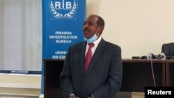 Paul Rusesabagina, the man who was hailed a hero in a Hollywood movie about Rwanda's 1994 genocide, is paraded in handcuffs in front of media at the headquarters of Rwanda's Investigation Bureau, in Kigali, Aug. 31, 2020.