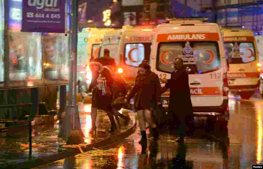 People run from a nightclub where a gun attack took place during a New Year party in Istanbul, Jan. 1, 2017.