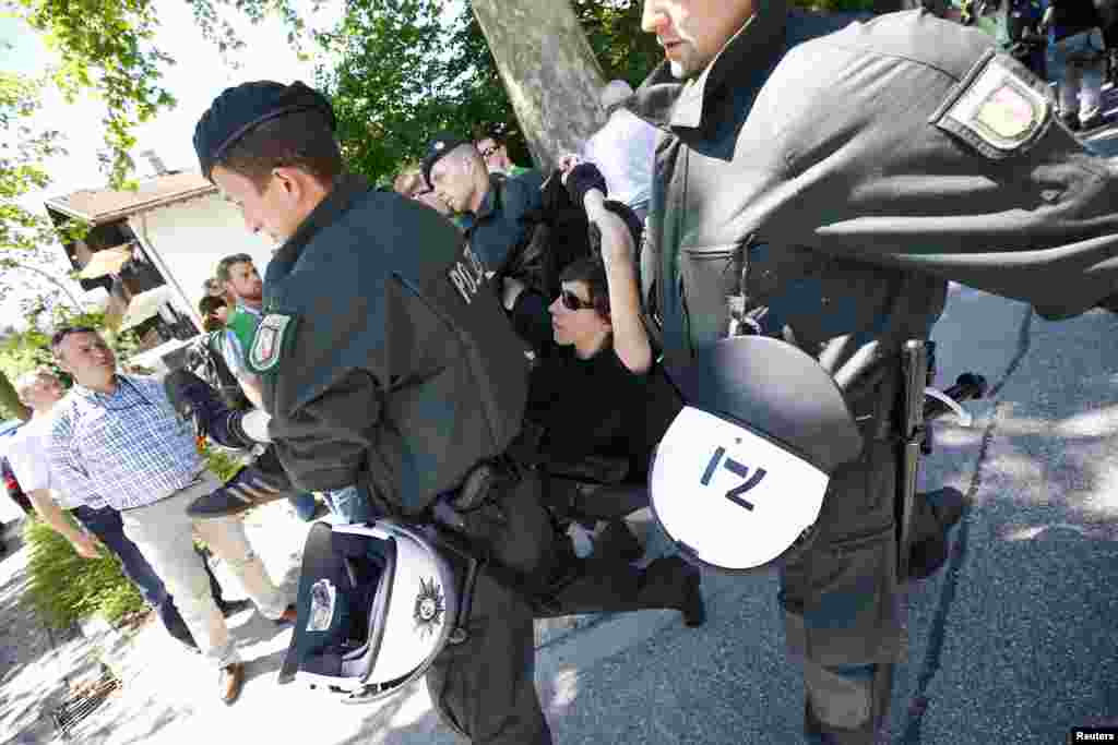 An ultra-Orthodox Jew gets hit by a police water canon during a protest against Israeli army conscription, in Jerusalem.