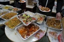 Protesters serve themselves with free Christmas dinner offered by a local restaurant in Hong Kong, Dec. 25, 2019.