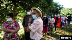 Personas hacen cola para emitir su voto durante las elecciones generales, en una escuela en Catacamas, Honduras, el 28 de noviembre de 2021.