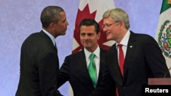 U.S. President Barack Obama (L) shakes hands with Canada's Prime Minister Stephen Harper (R) as Mexico's President Enrique Pena Nieto looks on after attending a news conference, at the North American Leaders' Summit in Toluca near Mexico City, Feb. 19, 20