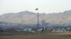FILE - North Korea's flag flies on a tower high above the village of Ki Jong Dong, as seen from an observation post in Panmunjom, March 25, 2012.