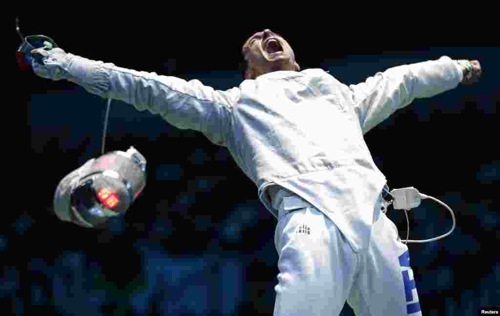 Italy's Diego Occhiuzzi reacts defeating his compatriot Aldo Montano (not seen) during their men's sabre individual round of 16 fencing competition at the ExCel venue at the London 2012 Olympic Games July 29, 2012