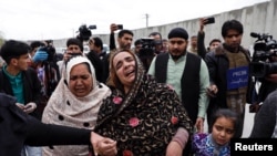 An Afghan Sikh woman mourns for her relatives near the site of an attack in Kabul, Afghanistan March 25, 2020.