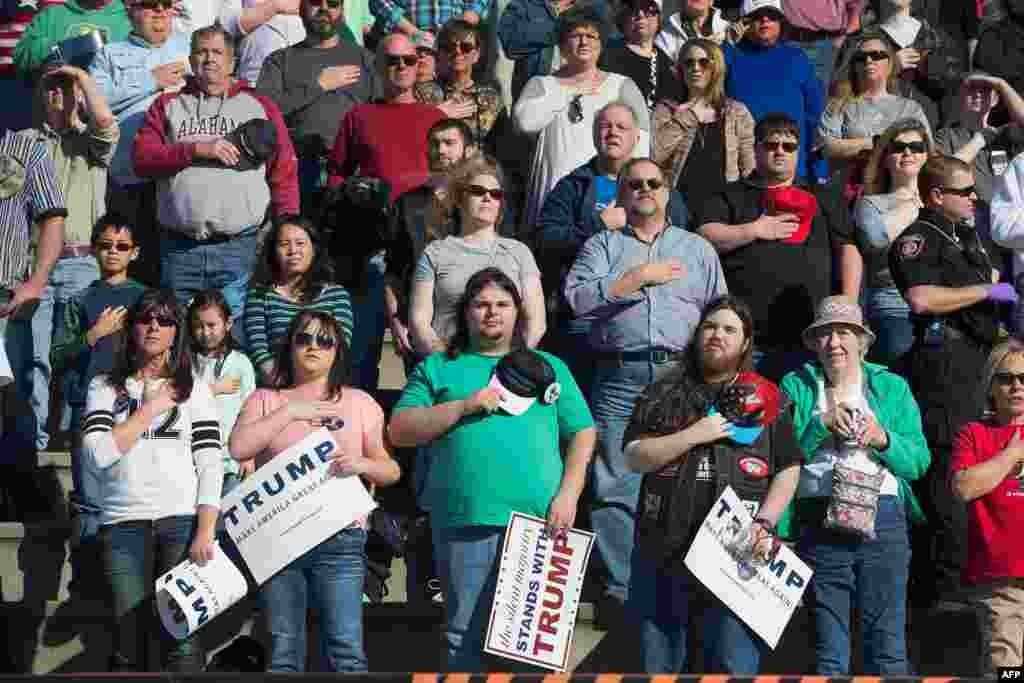 Guests listen to the national anthem during a campaign rally for Republican presidential candidate Donald Trump at the Madison City Schools Stadium in Madison, Alabama, Feb. 28, 2016.