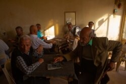 At a tea shop, Turkey Hussain, right, says Kurdish forces cannot win in a fight against Turkey without international support, in Dirik, Syria, Oct. 23, 2019. (Yan Boechat/VOA)