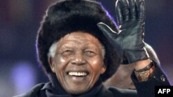 South Africa's former President Nelson Mandela waves as he arrives to attend the 2010 World Cup football final Netherlands vs. Spain on July 11, 2010 at Soccer City stadium in Soweto, suburban Johannesburg.