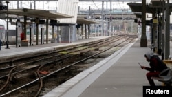 A man sits on a platform at the Gare Lille Flandres railway station a few hours before a nationwide strike by French SNCF railway workers, in Lille, France, April 2, 2018.