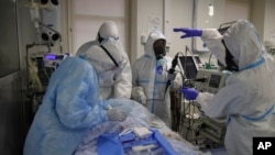 Medical staff members wearing special suits to protect against coronavirus treat a patient with coronavirus at an ICU at the Regional Clinical Hospital 1, in Krasnodar, south Russia, Nov. 2, 2021. 