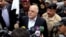 Iraqi Prime Minister Haider al-Abadi, center, raises an Iraqi flag in the city of Ramadi, 70 miles (115 kilometers) west of Baghdad, after it was retaken by the security forces, Dec. 29, 2015. 