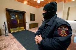 A Mississippi State Capitol police officer watches the main entrance on the north side of the statehouse in Jackson, Jan. 15, 2021. State capitols across the country are under heightened security ahead of Joe Biden's inauguration as president.