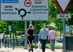 FILE - People cross the border between France and Spain at Behobie, southwestern France, June 21, 2020. Spain reopened its borders to European tourist in a bid to kickstart its economy.