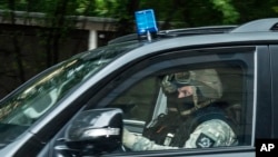 A police car leaves the district court in Dresden, eastern Germany, Oct. 10, 2016, after Jaber Albakr, 22, was arrested in the eastern city of Leipzig, following a nearly two-day manhunt.