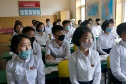 FILE - Students wearing face masks take a class at the Ryongwang Senior Middle School in Pyongyang, North Korea, June 3, 2020. After months of denying it had any coronavirus infections, North Korea reported its first suspected case July 25, 2020.
