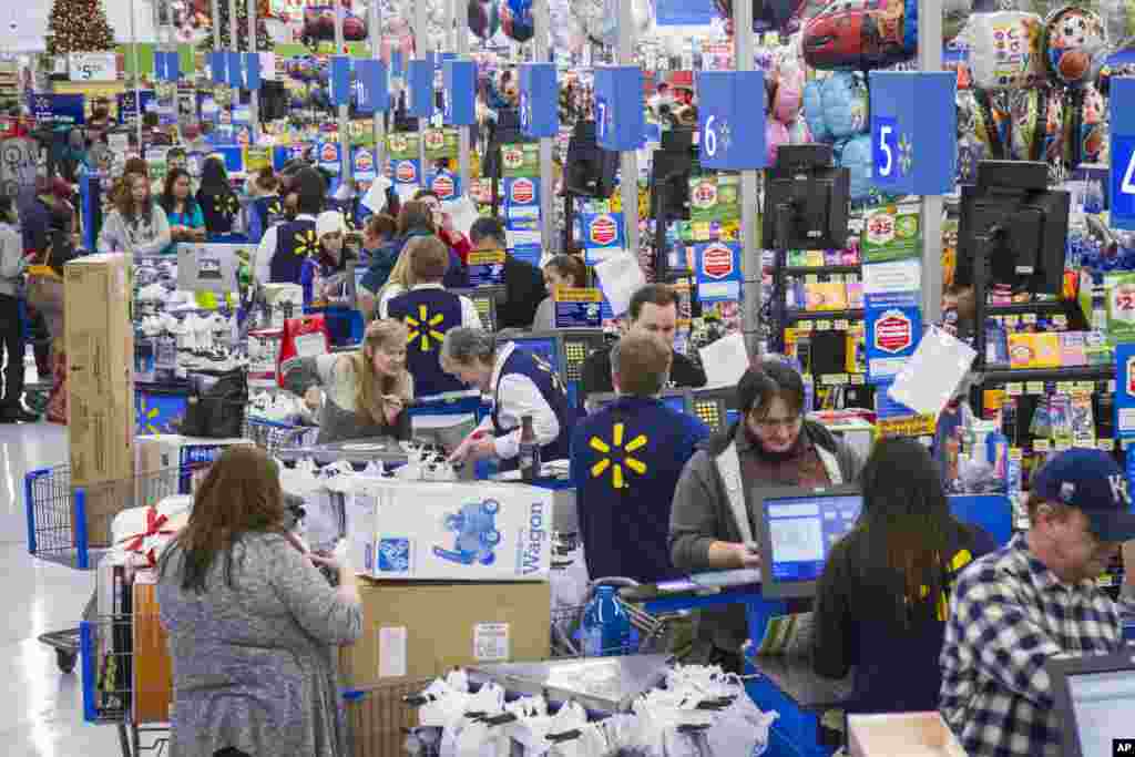 Customers wrap up their holiday shopping during Walmart's Black Friday events in Bentonville, Ark., Thursday, Nov. 27, 2014.