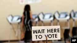 Pamela Hampton votes in Sandy Springs, Ga., May 9, 2018. Voting and cybersecurity experts say that if voting machines do not produce paper records of votes cast, double-checking the results for signs of manipulation is much more difficult.