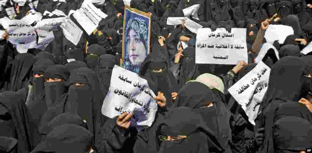 January 2011: Yemeni women hold placards and a photograph of activist Tawakkul Karman during an anti-government rally in Sanaa. Placards read in Arabic, &quot;Arresting Karman is an unethical incident against Yemeni Women.&quot; 