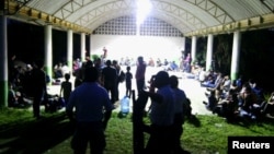 Central Americans are seen in the town of Tantima, Mexico, after Mexican authorities said that they rescued 147 Central Americans abandoned in the wilderness of Veracruz state, in this handout photograph released by the Mexican National Institute of Migration, July 30, 2017.