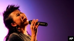 FILE - Hong Kong singer Coco Lee performs during a mini concert as celebrating an opening ceremony of a new hotel in Hong Kong, Aug. 19, 2005. Coco Lee, a Hong Kong-born singer who had a highly successful career in Asia, died July 5, 2023.