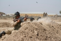 FILE - Iraqi soldiers train with members of the U.S. Army 3rd Brigade Combat Team, 82nd Airborne Division, at Camp Taji, Iraq, in this U.S. Army photo released June 2, 2015.