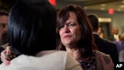 FILE - Sabine Durden (R), of Mineral Springs Ark., talks with Barbara Gonzalez, then-acting assistant director of Victims of Immigration Crime Engagement (VOICE) in Washington, April 26, 2017.