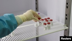Parents drop off their children at Southbank International School in London on March 8, 2021, as schools reopen following the easing of the coronavirus lockdown.