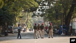 Indian police officers stand on a deserted street during an eleven hour general strike called by student organizations in Guwahati, India, Jan. 8, 2019, protesting a new citizenship bill.