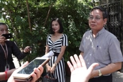 Pheng Heng, right, lawyer to former Cambodia National Rescue Party's President Kem Sokha, speaks to media in front of Kem Sokha's house in Phnom Penh, Cambodia, Nov. 10, 2019.