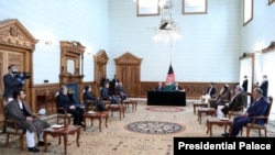Ghani-Abdullah deal signing in Kabul, Afghanistan, May 17, 2020, in the presence of senior political figures including former President Hamid Karzai. (Credit: Afghan Presidential Palace)