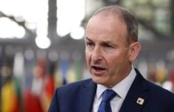 Ireland's Prime Minister Micheal Martin speaks with the media as he arrives for an EU summit in Brussels, Oct. 16, 2020.