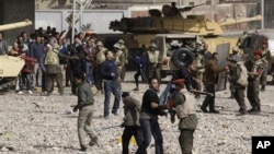 Pro-government supporters are restrained by soldiers just outside Cairo's main square, Feb. 3, 2011