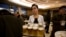 FILE - A North Korean waitress prepares to serve beer at the Mansugyo Soft Drink restaurant in Pyongyang.
