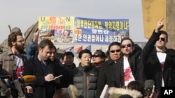 Thor Halvorssen, second right, the president of HRF, Human Rights Foundation, raises his arm and speaks during a press conference as Park Sang-hak, center, a North Korean Defector and the head of the Fighters for a Free North Korea, listens during a press