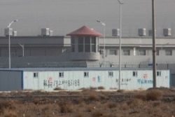 FILE PHOTO - In this Dec. 3, 2018, a guard tower and barbed wire fences are seen around a facility in the Kunshan Industrial Park in Artux in western China's Xinjiang region.