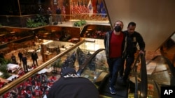 A demonstrator from the group Jewish Voice for Peace who protested inside Trump Tower in support of Columbia graduate student Mahmoud Khalil is escorted out by New York police officers after being arrested, March 13, 2025, in New York.