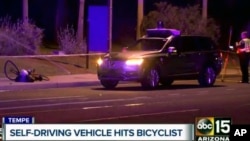 A still image taken from video provided by ABC-15, shows investigators at the scene of a fatal accident involving a self-driving Uber car on the street in Tempe, Arizona, March 19, 2018. . 
