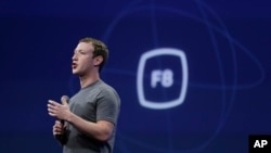 FILE - In this March 25, 2015, file photo, CEO Mark Zuckerberg gestures while delivering the keynote address at the Facebook F8 Developer Conference in San Francisco. Zuckerberg said Tuesday, Sept. 15, Facebook may finally be getting a button that lets yo