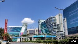 Messages to practice social distancing and frequent disinfection are displayed on a building in the business hub of Gurugram that adjoins New Delhi. (Anjana Pasricha/VOA)