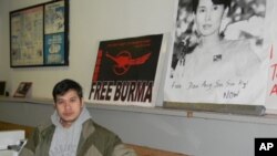 Zah Win in his Buffalo, New York, laundromat where the walls are covered with posters denouncing Burma’s military junta.