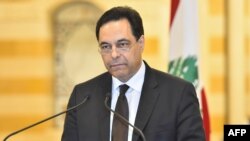 A handout picture provided by the Lebanese photo agency Dalati and Nohra, Aug. 10, 2020 shows Prime Minister Hassan Diab announcing his government's resignation amid popular outrage over the deadly Beirut port explosion.