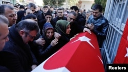 Relatives of Fatih Cakmak, a security guard and a victim of an attack by a gunman at the Reina nightclub, attend his funeral in Istanbul, Turkey, Jan. 2, 2017. 