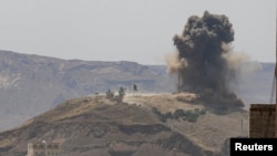 Smoke and dust rise from the site of an airstrike on the outskirts of Sanaa, Yemen, July 1, 2020.