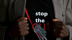 FILE - A man shows the logo of a T-shirt that reads "Stop the Cut" referring to female genital mutilation, during an event advocating against harmful practices such as FGM at the Imbirikani Girls High School in Imbirikani, Kenya, April 21, 2016.