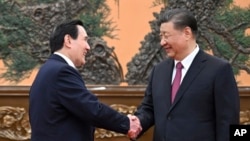 Chinese President Xi Jinping, right, shakes hands with former Taiwanese President Ma Ying-jeou as they meet in Beijing on April 10, 2024, in a bid to promote unification between the sides that separated amid civil war in 1949. (Xinhua News Agency via AP)