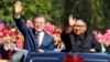 South Korean President Moon Jae-in and North Korean leader Kim Jong Un wave during a car parade in Pyongyang, North Korea, Sept. 18, 2018. 
