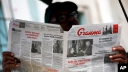FILE - A man reads the official newspaper of the Central Committee of the Cuban Communist Party, Granma, in old Havana, Feb. 3, 2015.