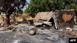 FILE - A picture taken Dec. 17, 2018, shows houses burned down by Boko Haram fighters in Maiborti village, Maiduguri, Nigeria. Fighters from the Islamic State West Africa Province overran military posts in Borno state on Jan. 1, 2019, sources reported.