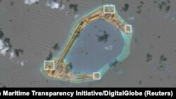 A satellite image shows what CSIS Asia Maritime Transparency Initiative says appears to be anti-aircraft guns and what are likely to be close-in weapons systems (CIWS) on the artificial island Subi Reef in the South China Sea in this image released on Dec